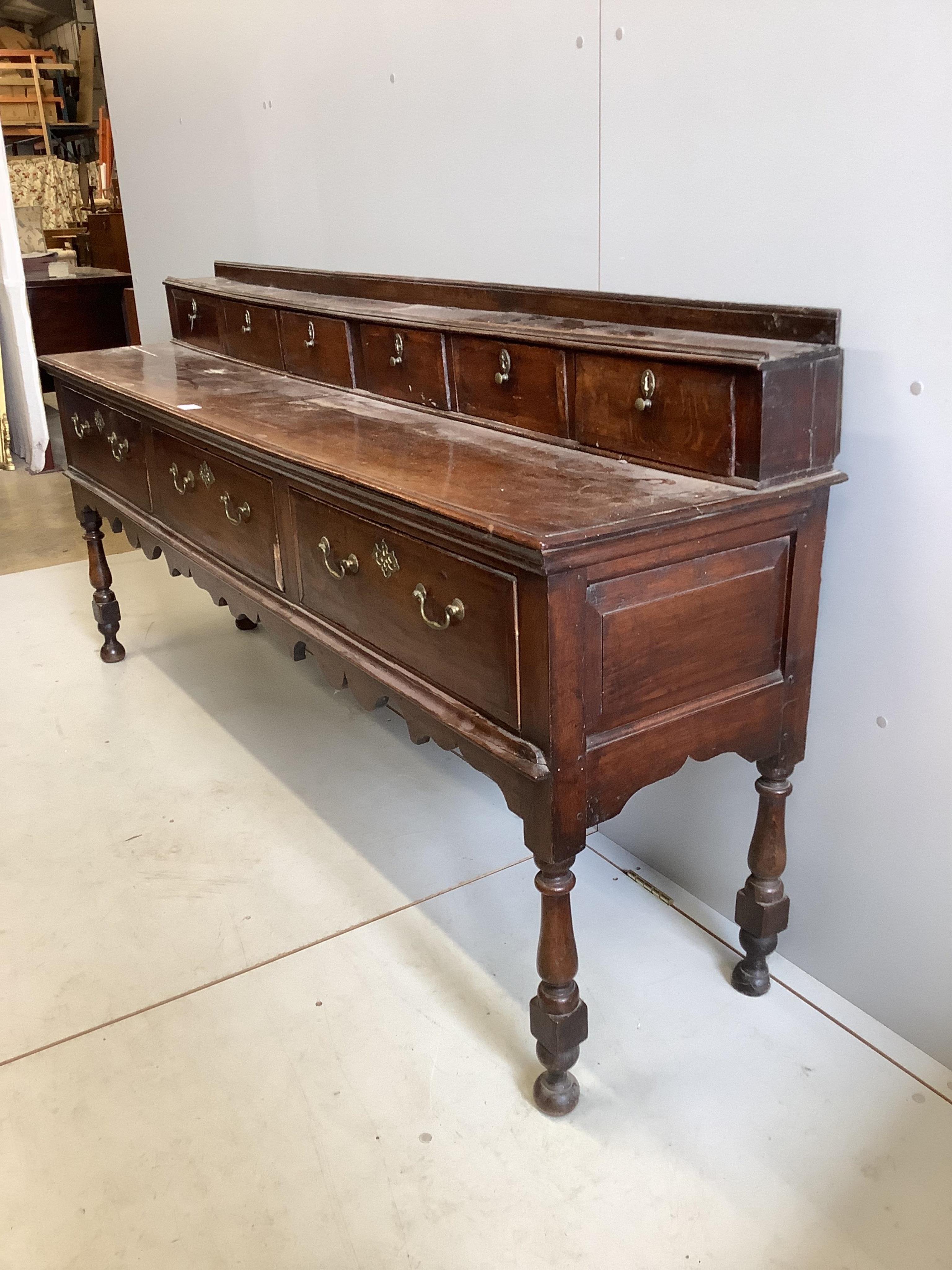 A mid 18th century oak low dresser, width 207cm, depth 46cm, height 97cm. Condition - fair